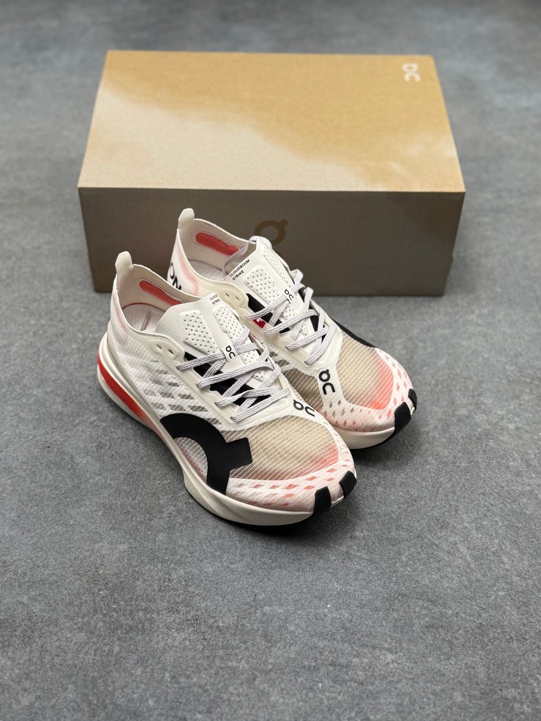 On Cloudboom Strike Cream & Red Sneakers