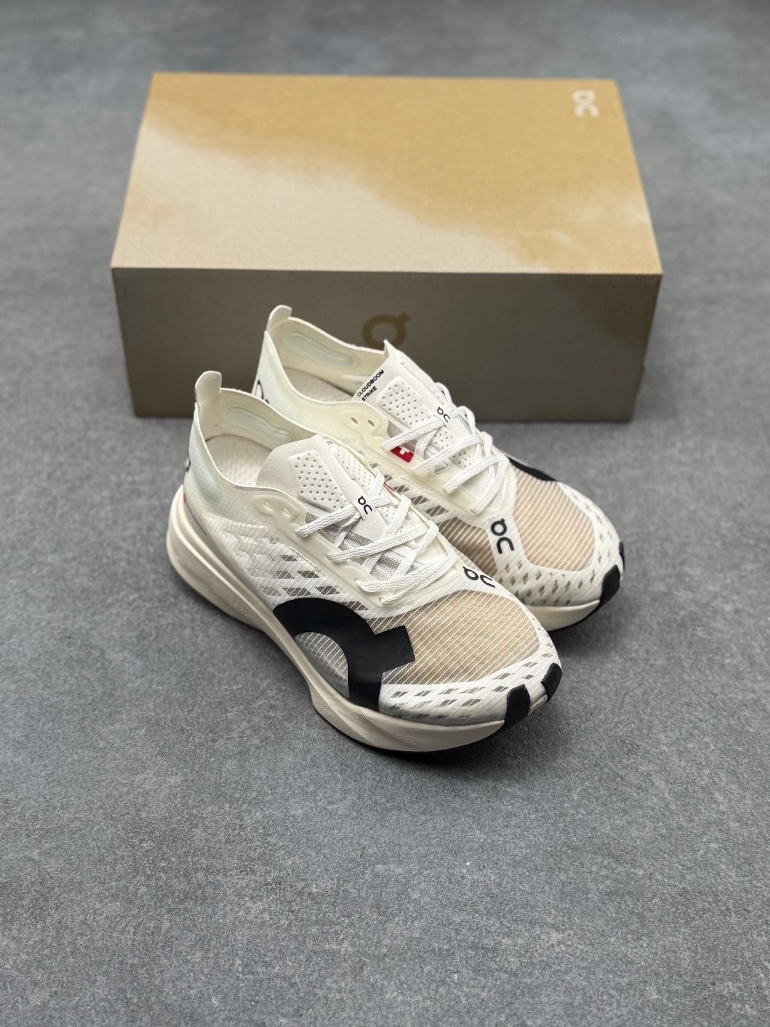 On Cloudboom Strike Cream Sneakers