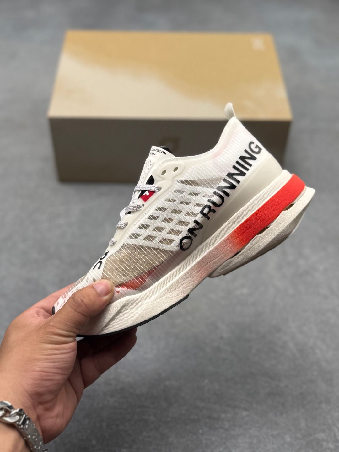On Cloudboom Strike Cream & Red Sneakers