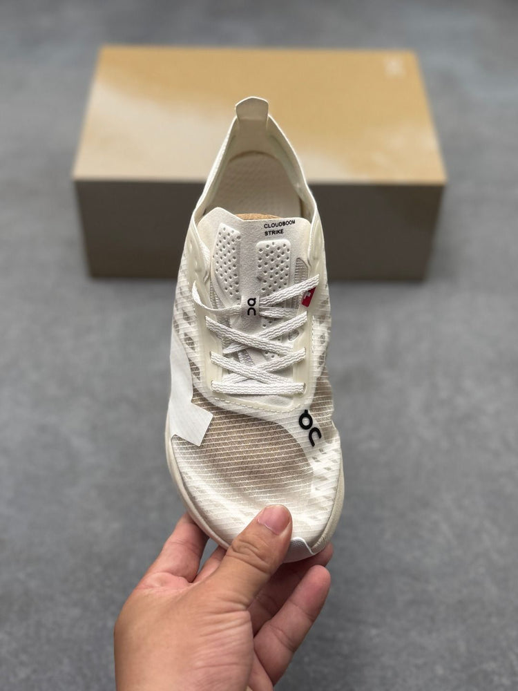 On Cloudboom Strike Cream Sneakers