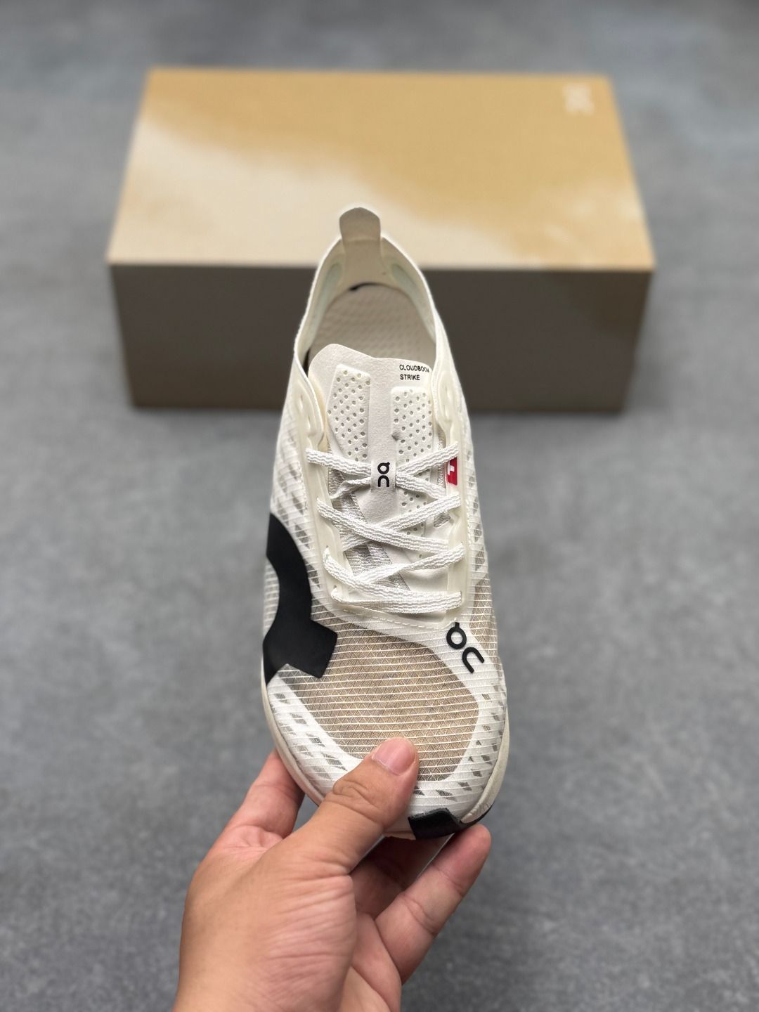 On Cloudboom Strike Cream Sneakers